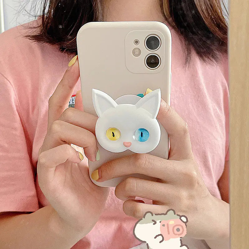 3D Cat Phone Holder Griptok - Mobile AccessoriesA handmade 3D cat-shaped phone holder grip designed for iPhone users. It offers: A secure, anti-drop grip for everyday use Stylish and charming design that adds personality to your device Versatility for scrolling, selfies, videos, and even home or car decor  Perfect for upgrading your phone accessories with both function and flair. Let me know if you&